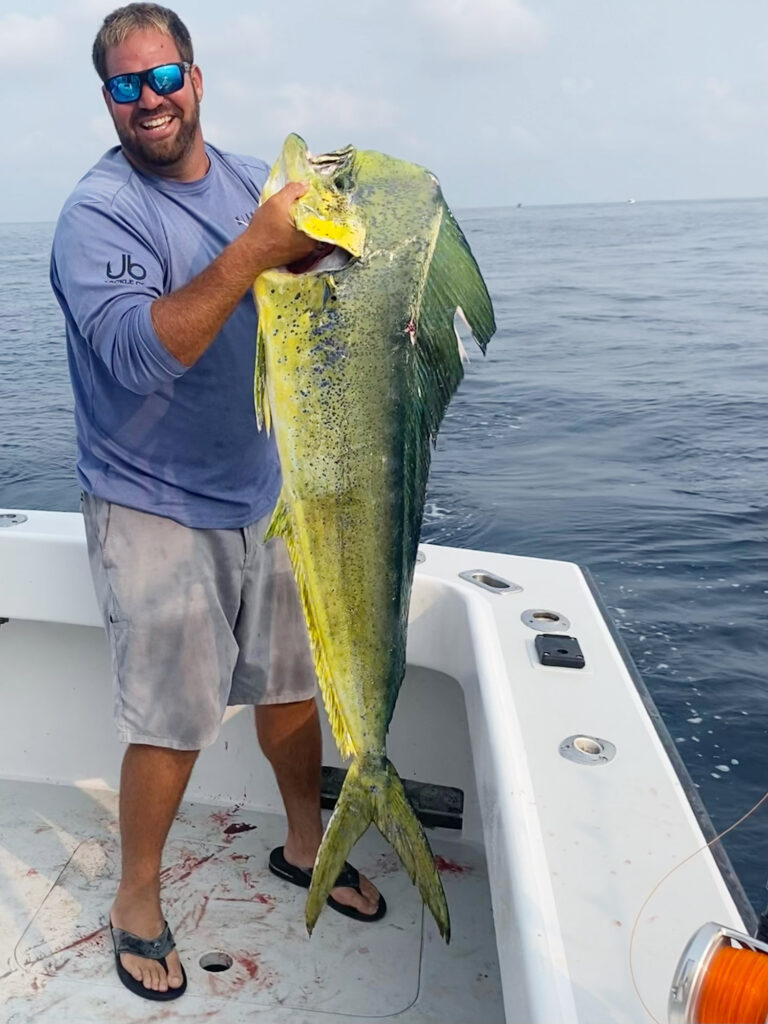 Angler holds a large dolphinfish caught off Rhode Island at Block Canyon.