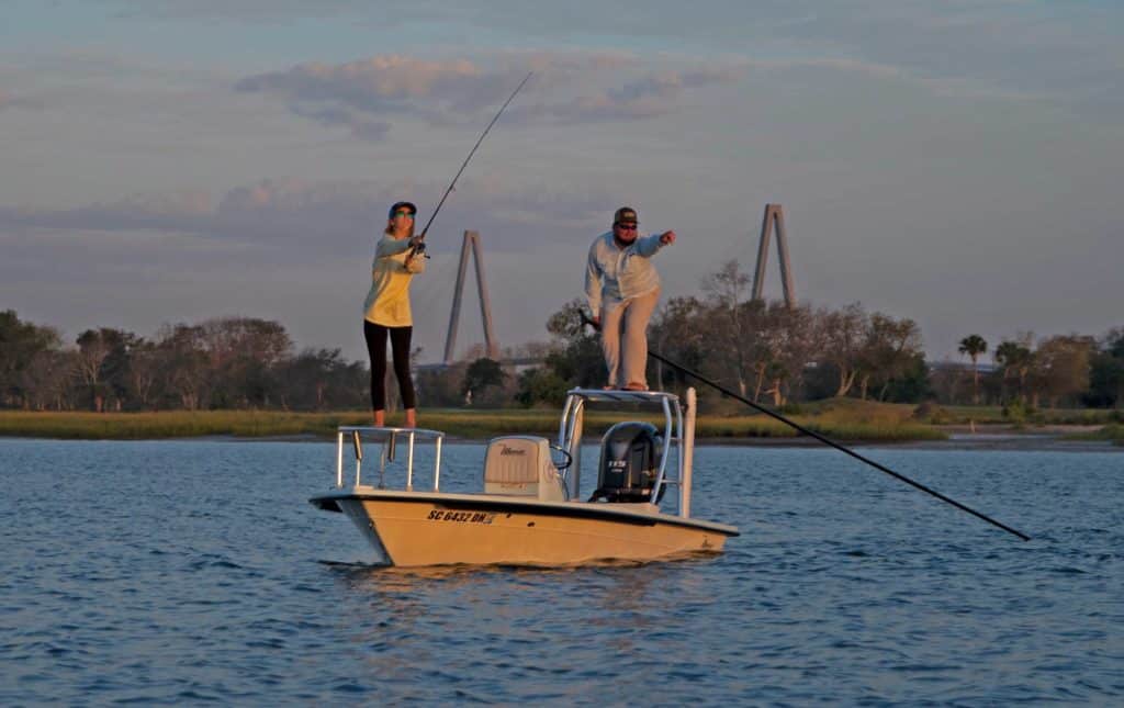 Anglers fishing from a skiff at sunset