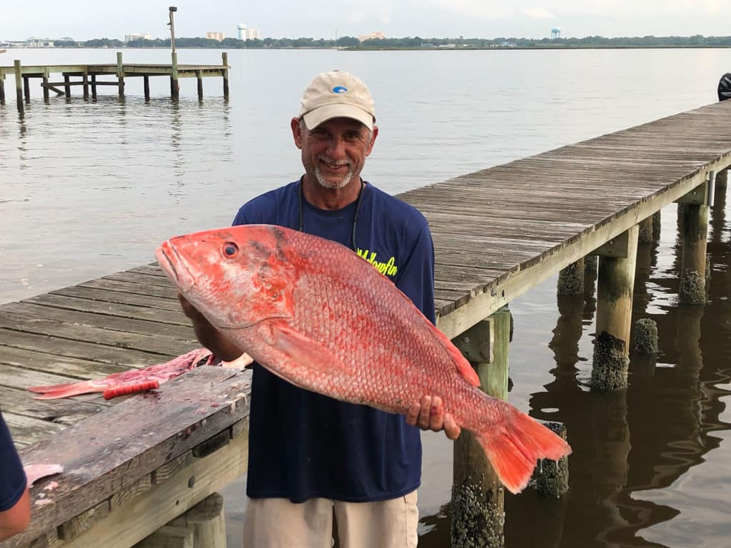 Angler holding red snapper